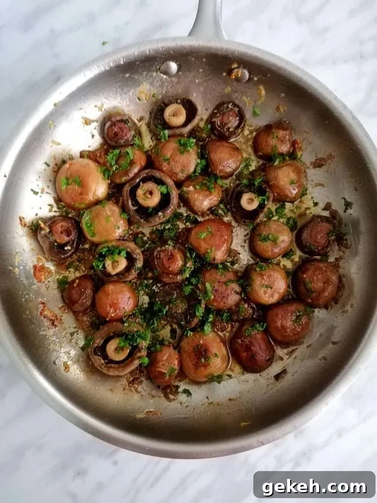 7 Classic Thanksgiving Sides to Make This Year 7 garlic butter mushrooms in skillet with parsley