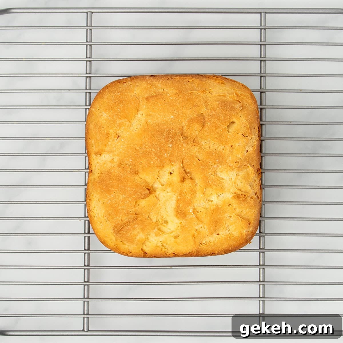 image of top of bread machine bread on wire silver metal rack