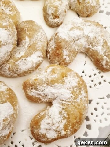 Walnut crescent cookies on a doily.