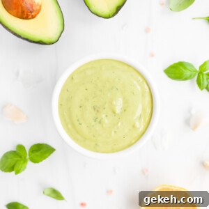 A small white bowl filled with creamy green sauce.