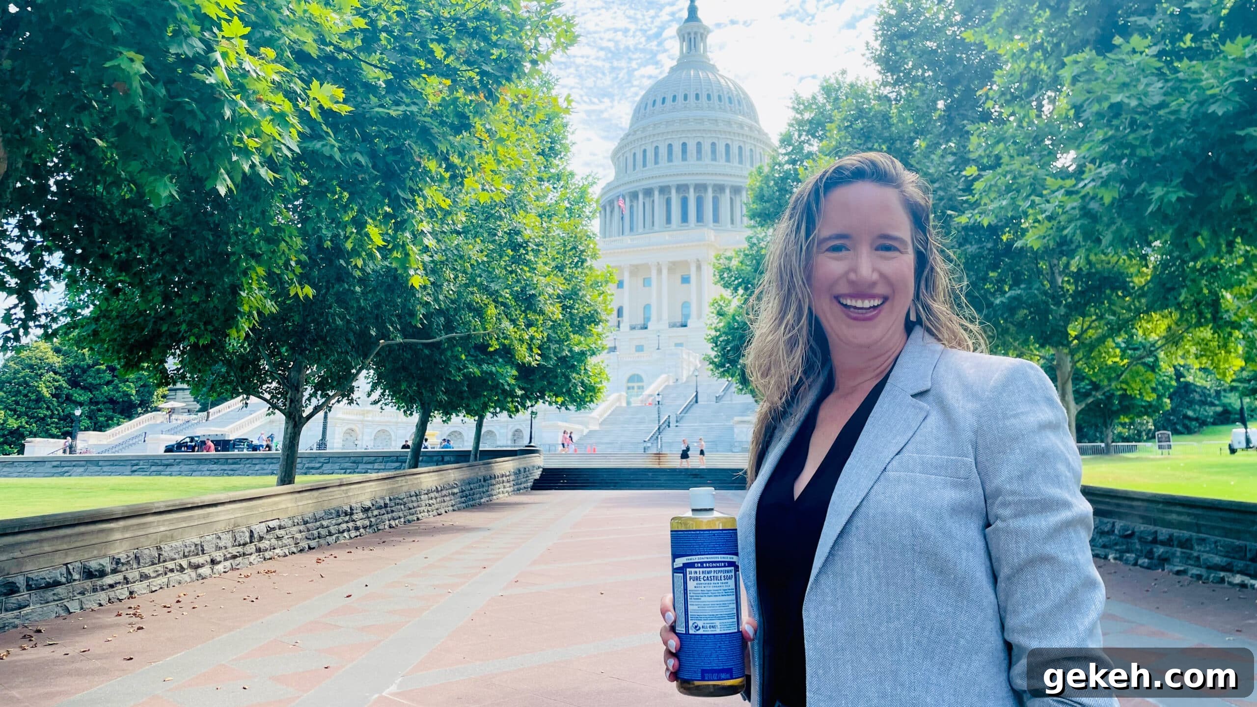 5 Key Lessons from My Advocacy Days in Washington, D.C. 2 Lisa Bronner standing in front of the capitol building, smiling with a bottle of Dr. Bronner's Castile Soap in her hand.