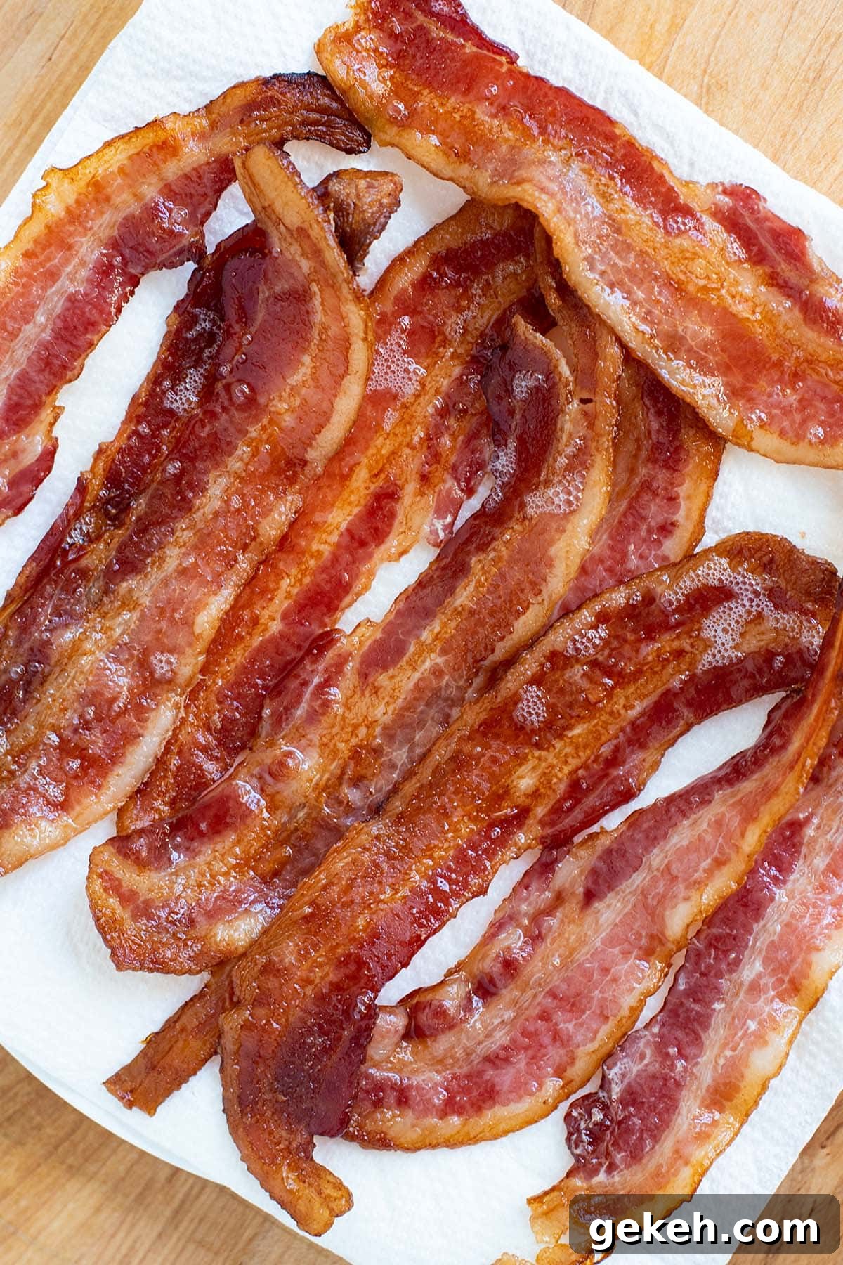 Perfectly Crispy Oven-Baked Bacon: Simple Sheet-Pan Method 2 Crispy browned bacon draining on a paper towel.