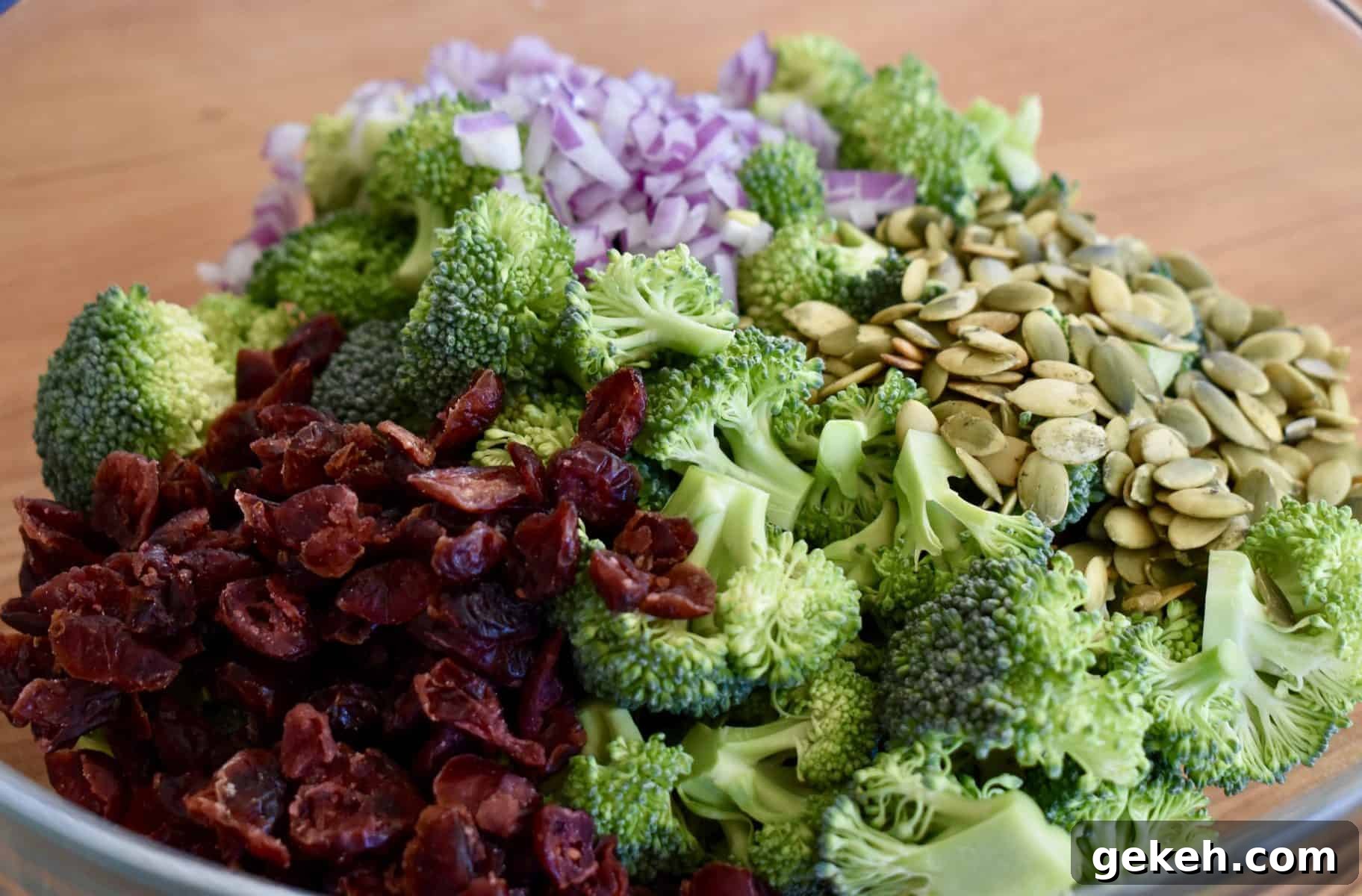Broccoli and Cranberry Salad with Creamy Greek Yogurt Dressing 4 broccoli, cranberries, red onions, and sunflower seeds in a large glass bowl.