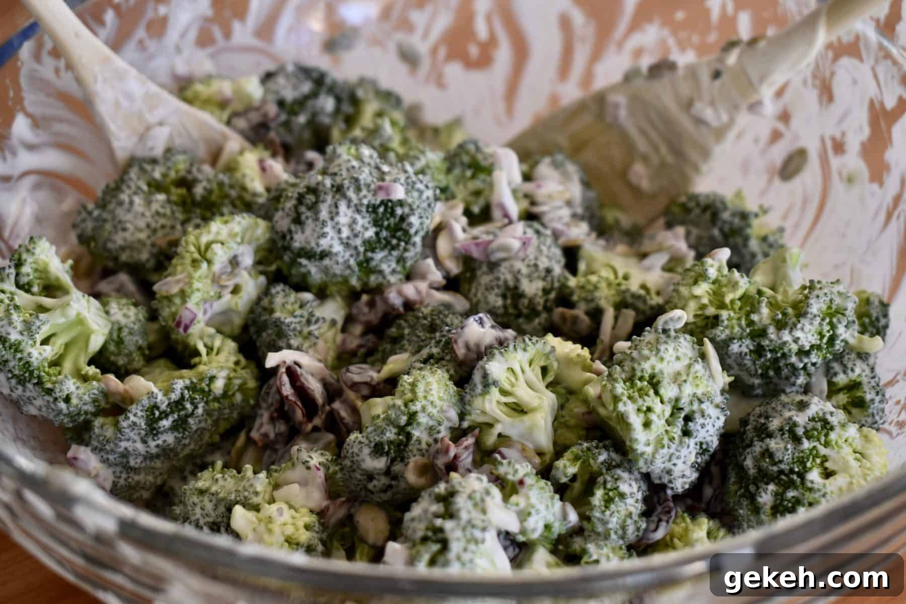 Broccoli and Cranberry Salad with Creamy Greek Yogurt Dressing 7 tossed broccoli cranberry salad with greek yogurt dressing in a glass bowl.
