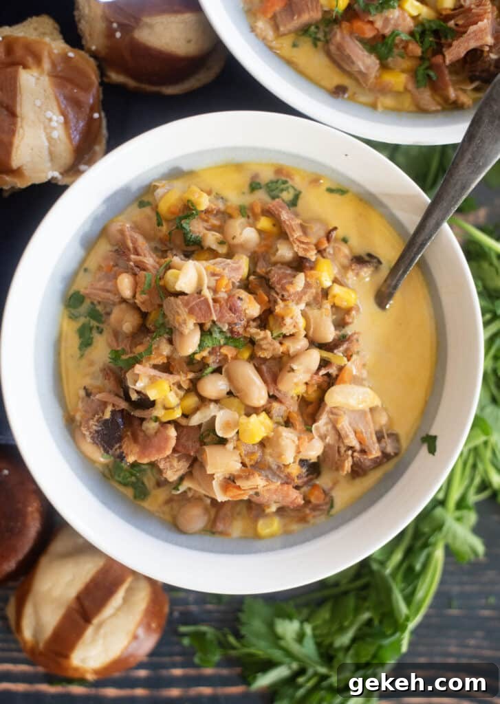 Creamy ham white bean soup in rustic bowl with parsley garnish and crusty bread