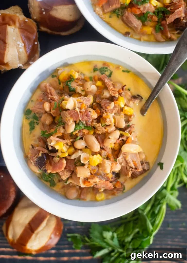 Creamy ham white bean soup in rustic bowl with parsley garnish and crusty bread