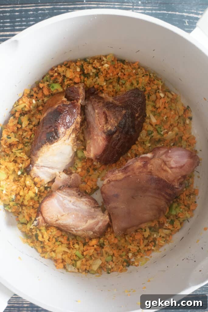 Adding ham hocks and ham bone to simmering white bean soup