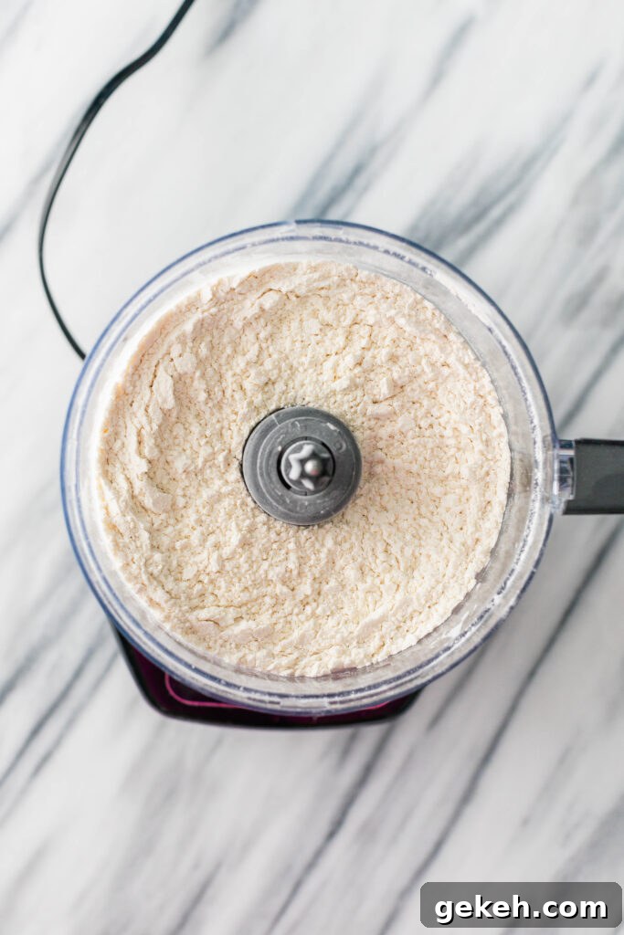 pulsing dry ingredients and cubed cold butter in a food processor