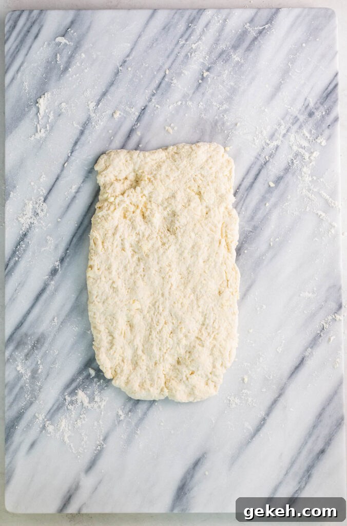 old fashioned buttermilk biscuits dough turned out on floured marble slab