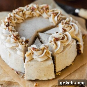 Angled overhead image of sliced 6 inch single layer carrot cake on parchment paper with bowls of nuts, frosting, and a knife in the background on wood table.