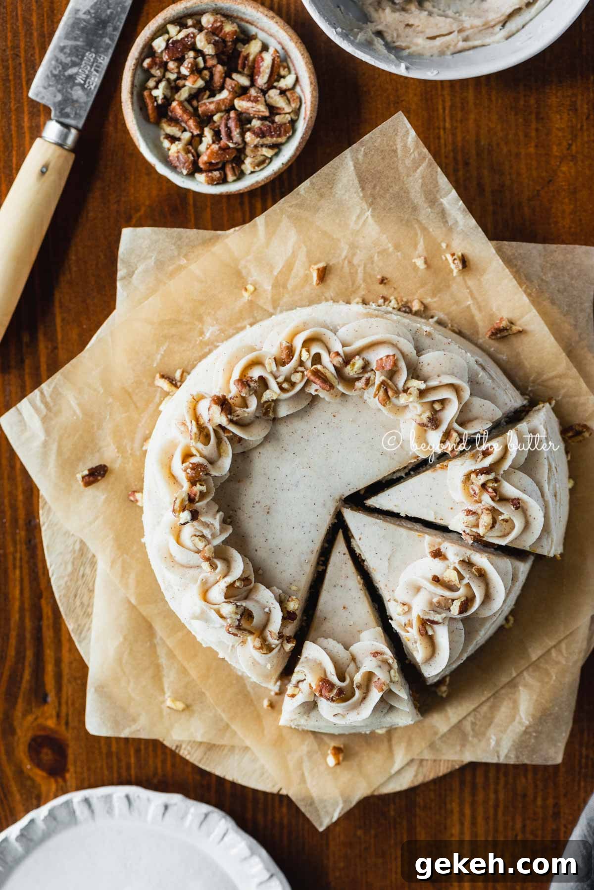 Overhead image of sliced 6 inch single layer carrot cake on parchment paper | All Images © Beyond the Butter®