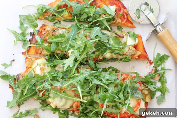 Packed with brussels sprouts, mushrooms, cauliflower, spinach and topped with piles of fresh arugula, this Leek & Mushroom pizza is a veggie lover's dream!