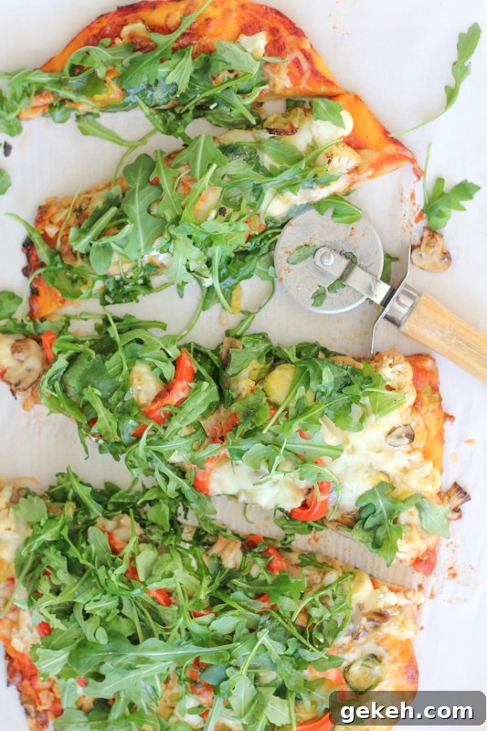 Packed with brussels sprouts, mushrooms, cauliflower, spinach and topped with piles of fresh arugula, this Leek & Mushroom pizza is a veggie lover's dream!