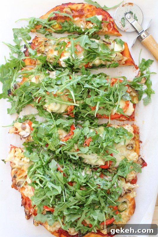 Packed with brussels sprouts, mushrooms, cauliflower, spinach and topped with piles of fresh arugula, this Leek & Mushroom pizza is a veggie lover's dream!