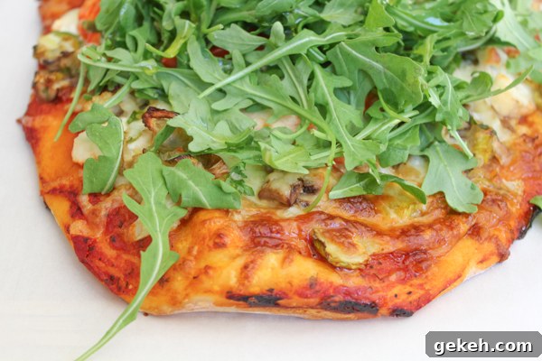 Packed with brussels sprouts, mushrooms, cauliflower, spinach and topped with piles of fresh arugula, this Leek & Mushroom pizza is a veggie lover's dream!
