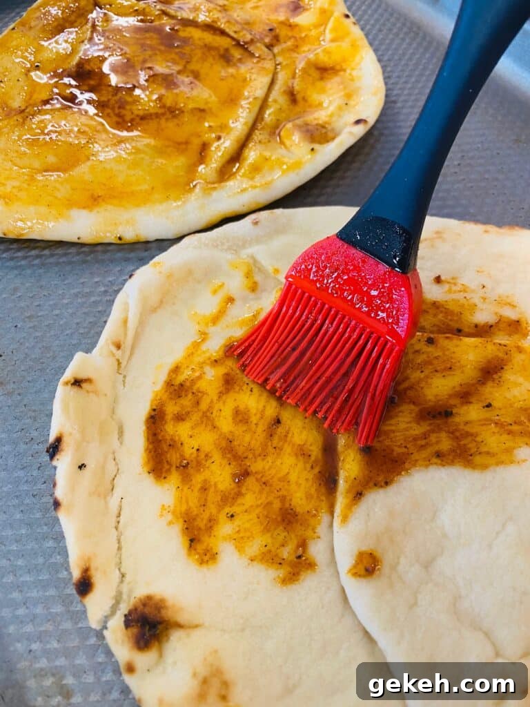 Nashville Hot Chicken Flatbreads on the Traeger Grill 5 brushing the Nashville hot butter on the flatbreads