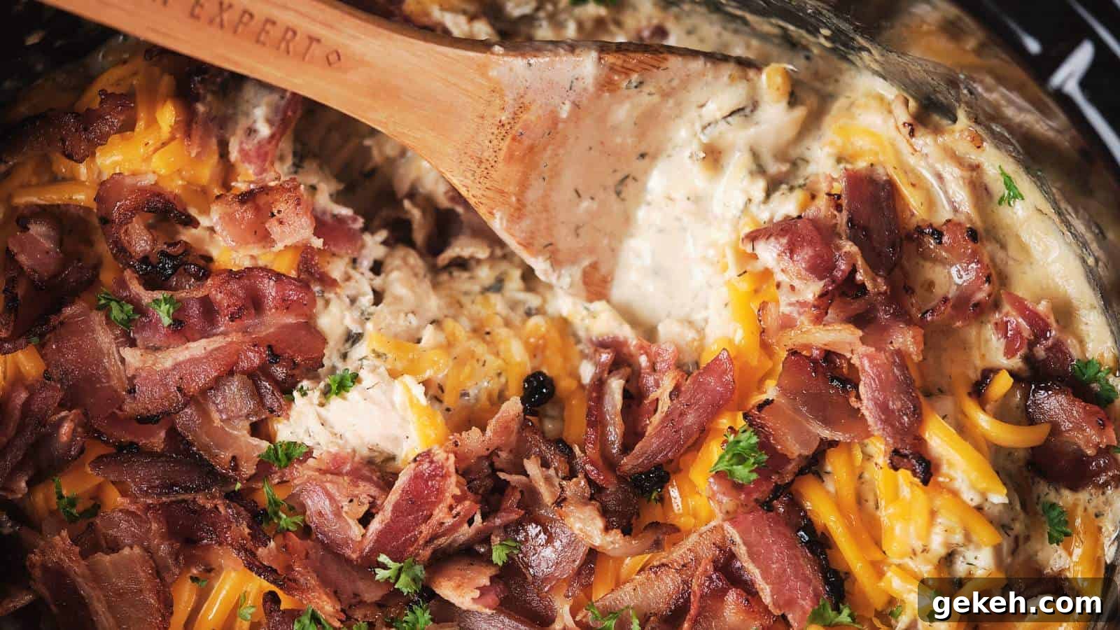 15 Sophisticated Dinner Ideas to Impress with Minimal Effort 11 Cheesy chicken topped with crispy bacon and sprinkled with parsley in a black dish.
