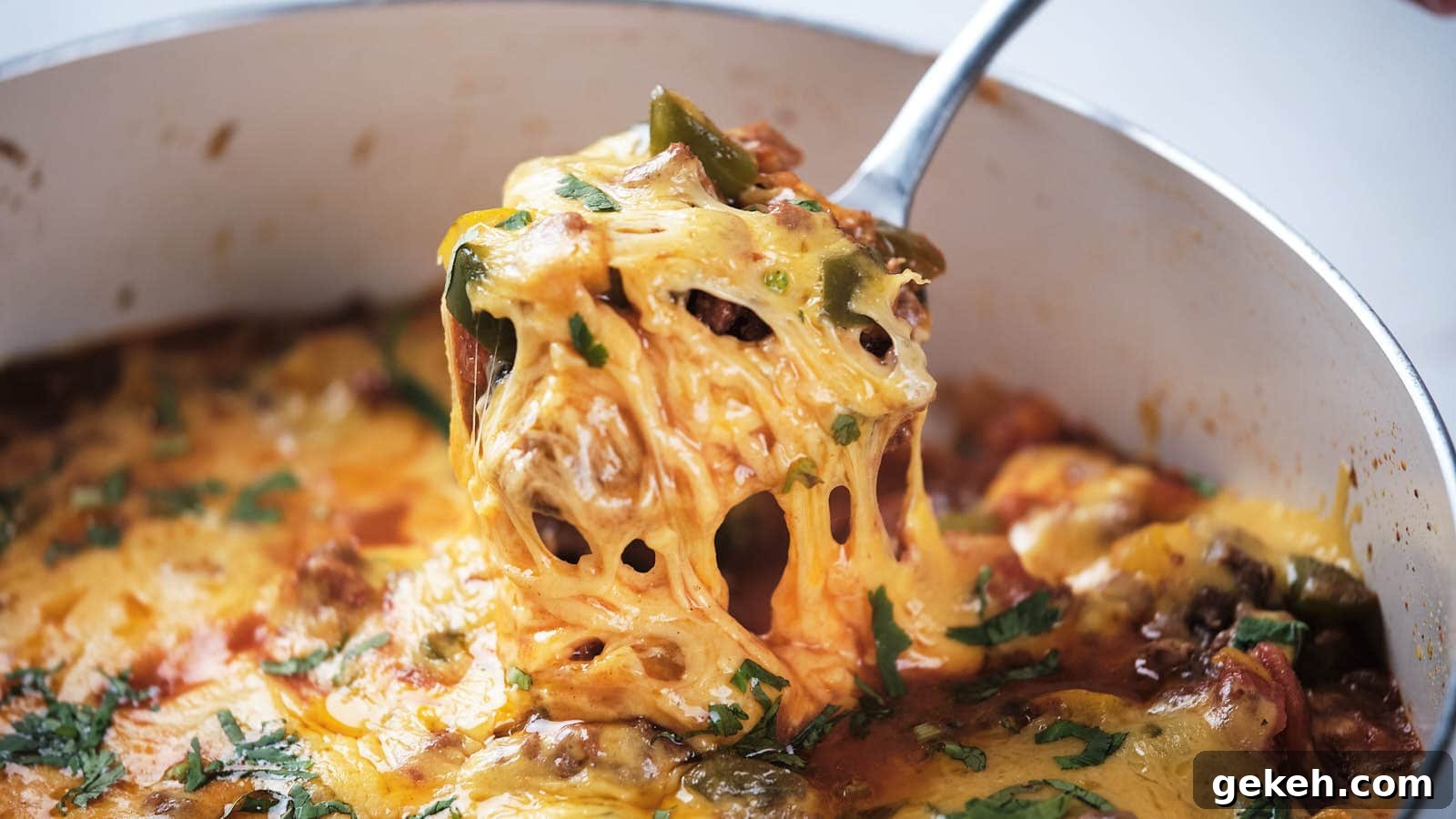 15 Sophisticated Dinner Ideas to Impress with Minimal Effort 3 A close-up of ground beef taco skillet being served with a metal spoon.