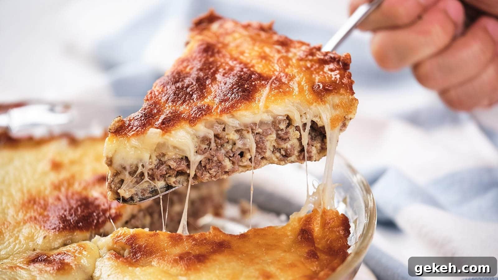 15 Sophisticated Dinner Ideas to Impress with Minimal Effort 7 A slice of cheesy meat pie being lifted, showing melted cheese and meat layers.