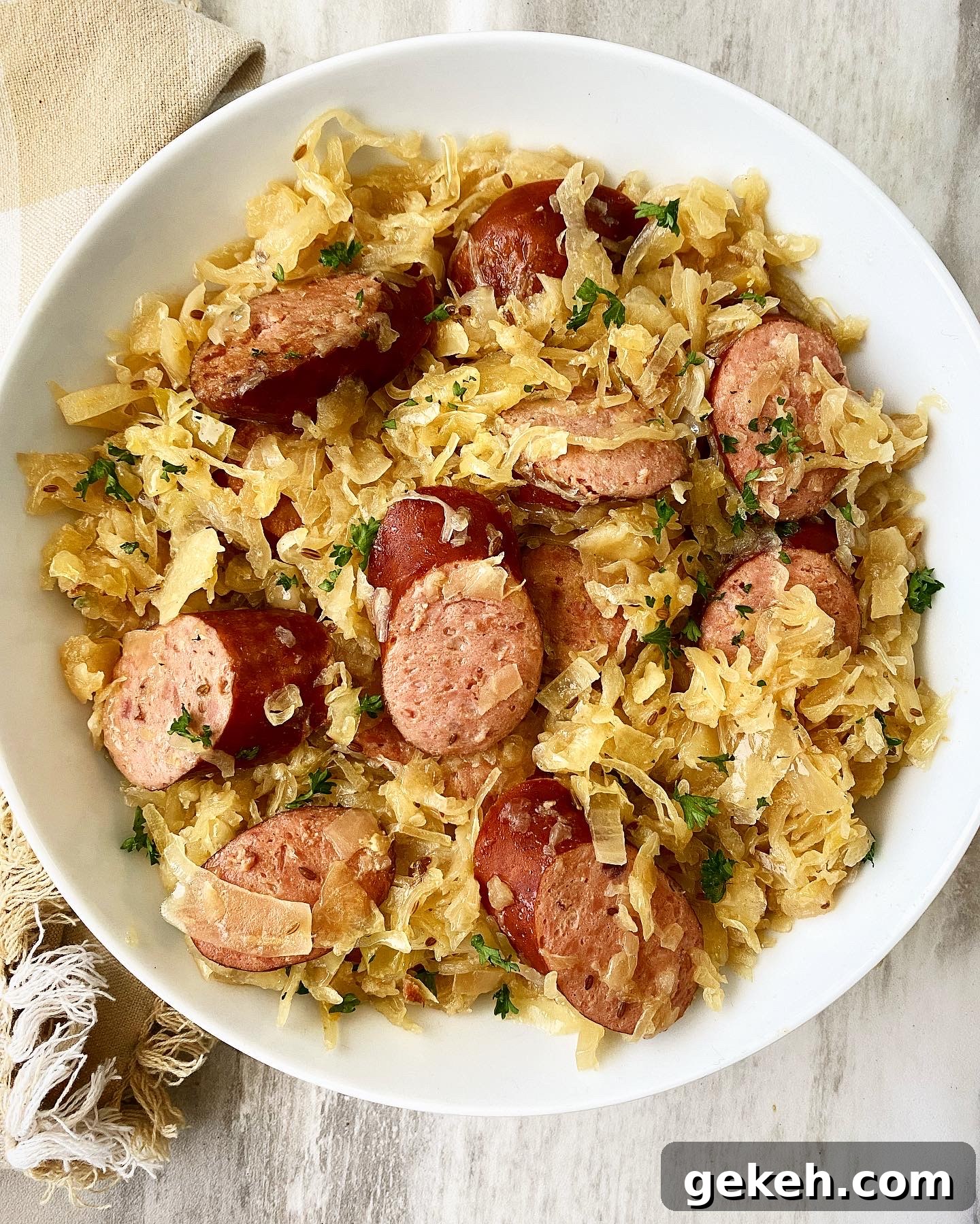 Slow Cooker Sausage with Sauerkraut: Simple Comfort Meal 2 overhead shot of Sausage & Sauerkraut in a white bowl