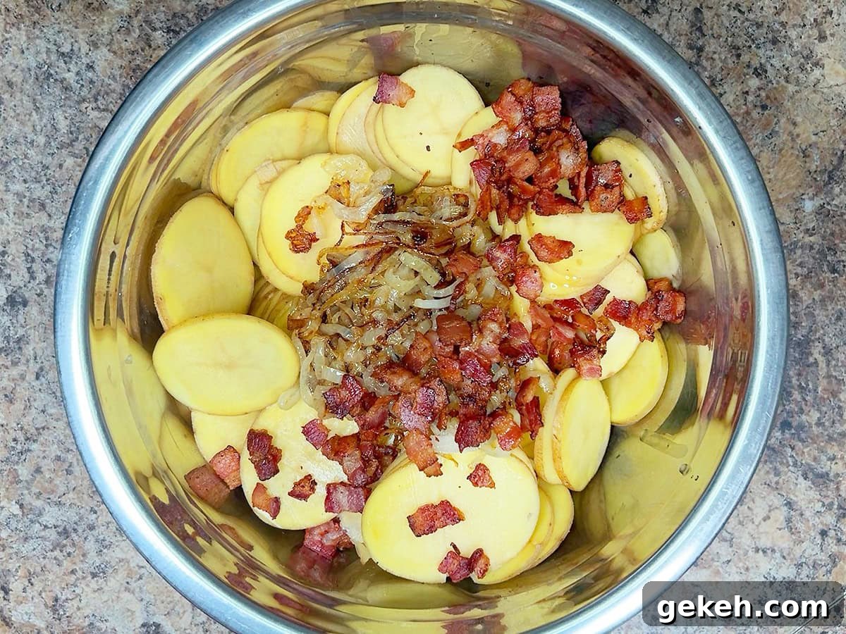 Creamy Scalloped Potatoes with Crispy Bacon 15 Sliced potatoes, onions, and cooked bacon in a large mixing bowl.