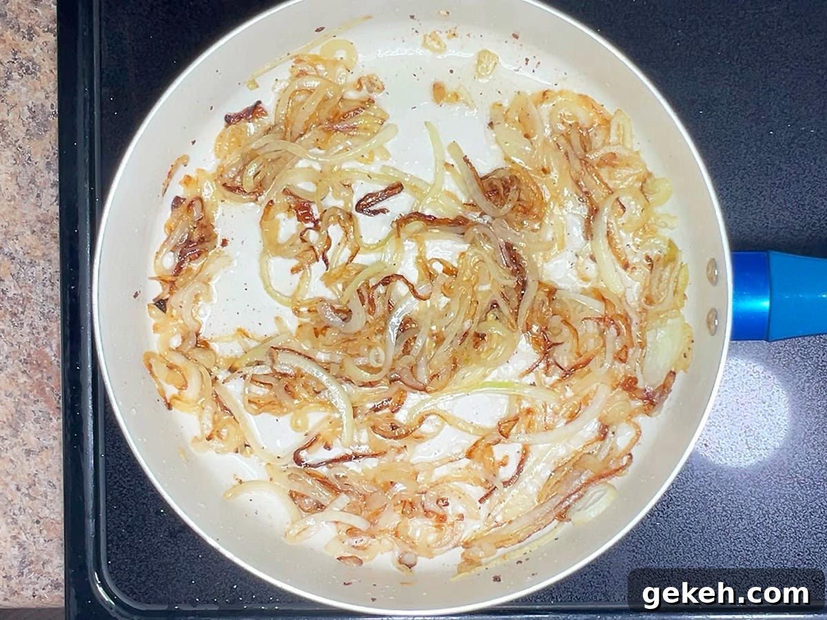 Creamy Scalloped Potatoes with Crispy Bacon 7 Onions in a large skillet after they have been caramelized.