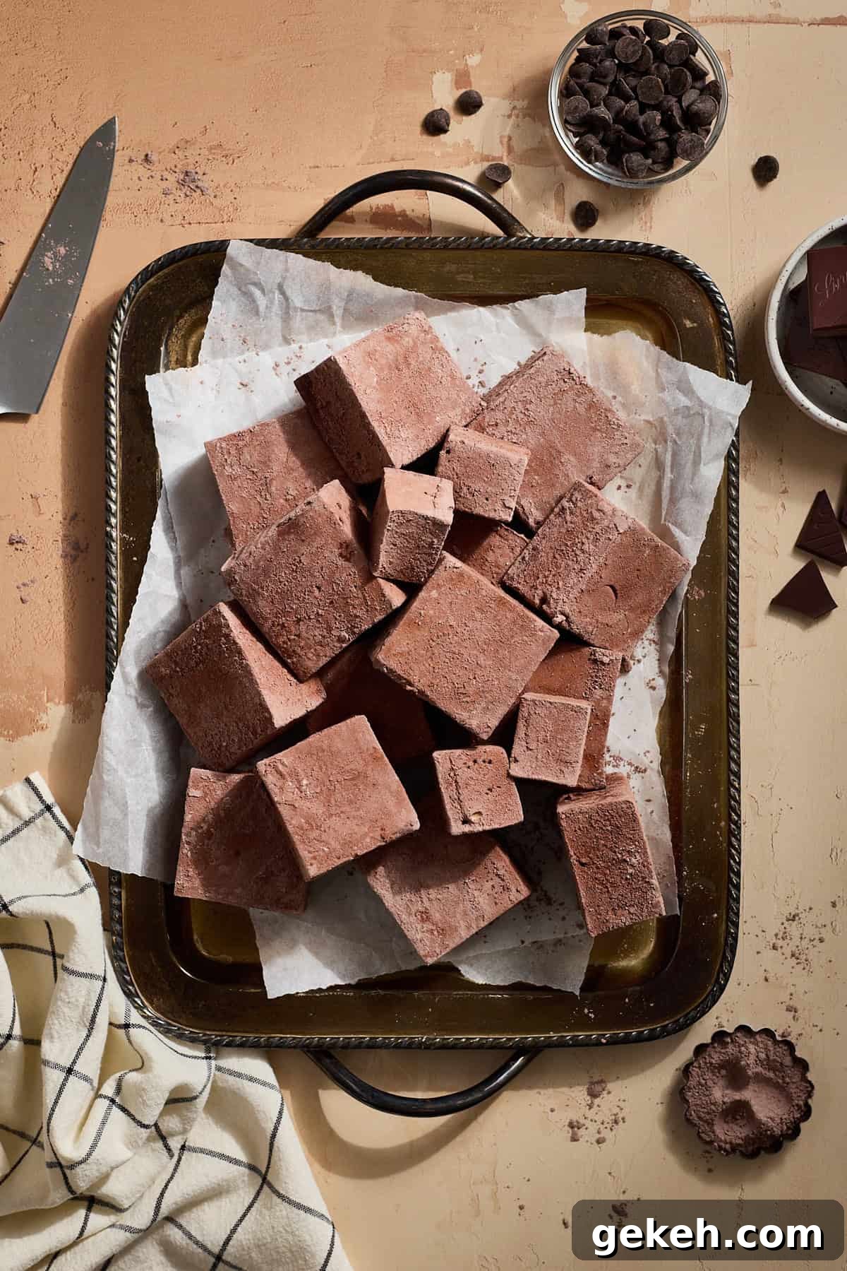 A pile of Chocolate Marshmallows on a silver tray. 
