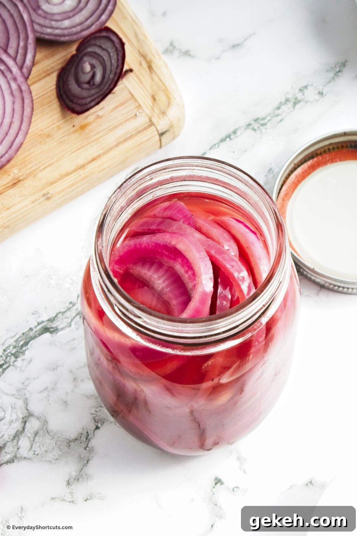 Crisp Quick-Pickled Red Onions for Toppings and Salads 8 onions marinated with pickling mixture in a jar