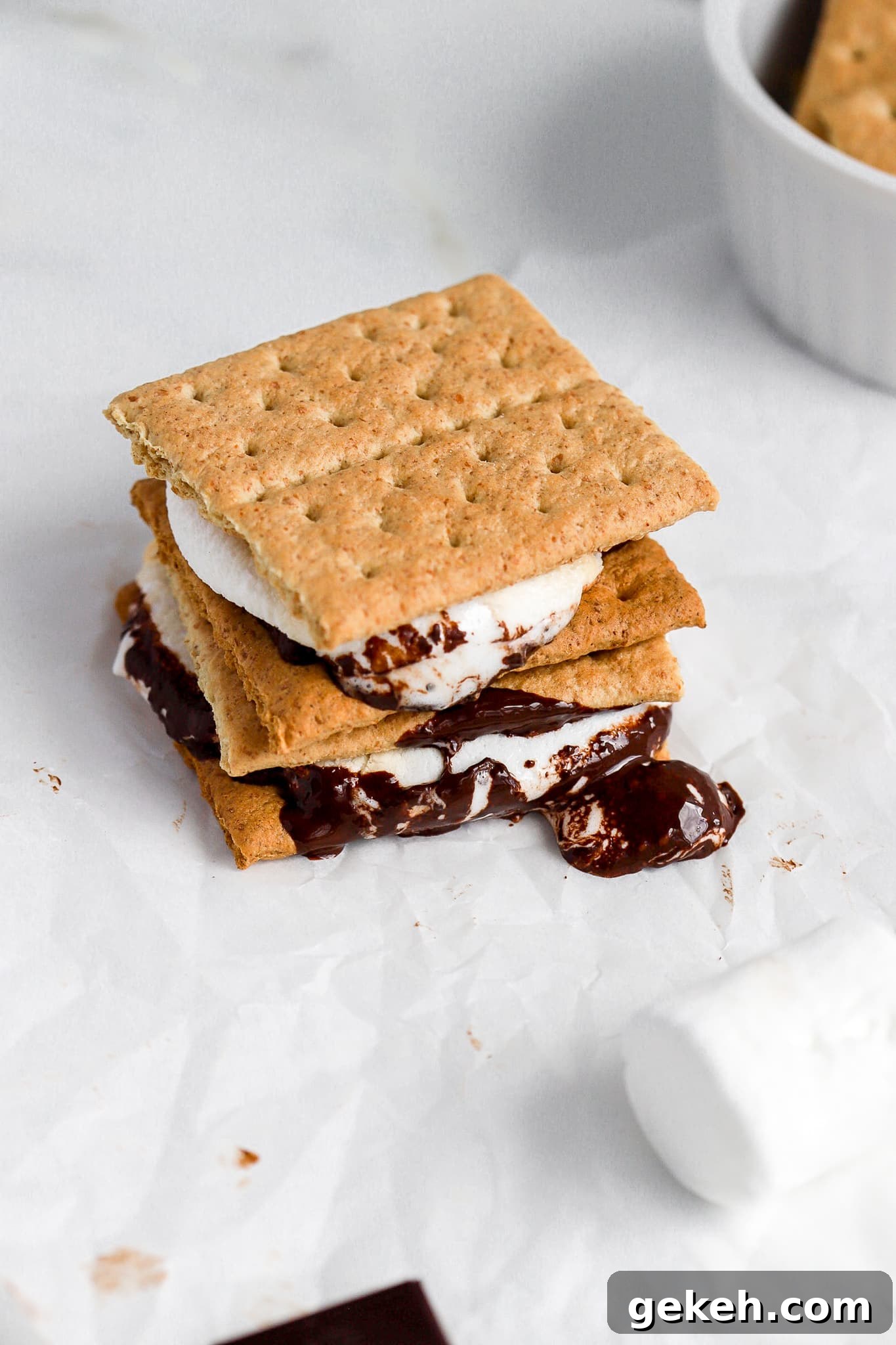 Air Fryer S'mores Recipe: Quick, Crispy S'mores in Minutes 3 close up shot of air fryer s'more with melted chocolate on parchment paper