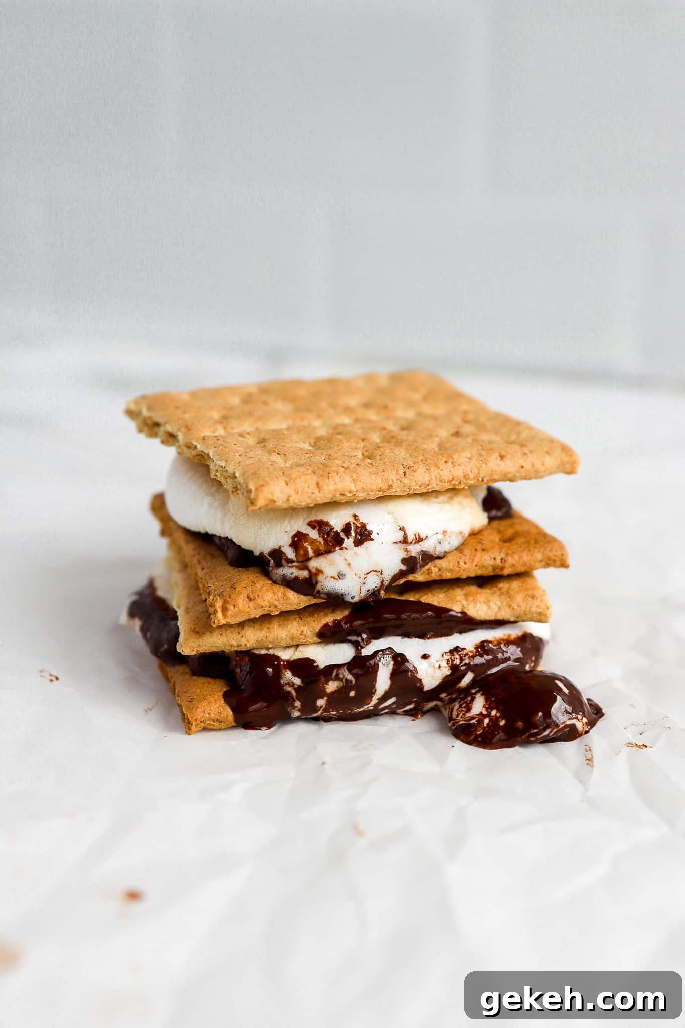 Air Fryer S'mores Recipe: Quick, Crispy S'mores in Minutes 6 two s'mores stacked on top of each other with melted dark chocolate